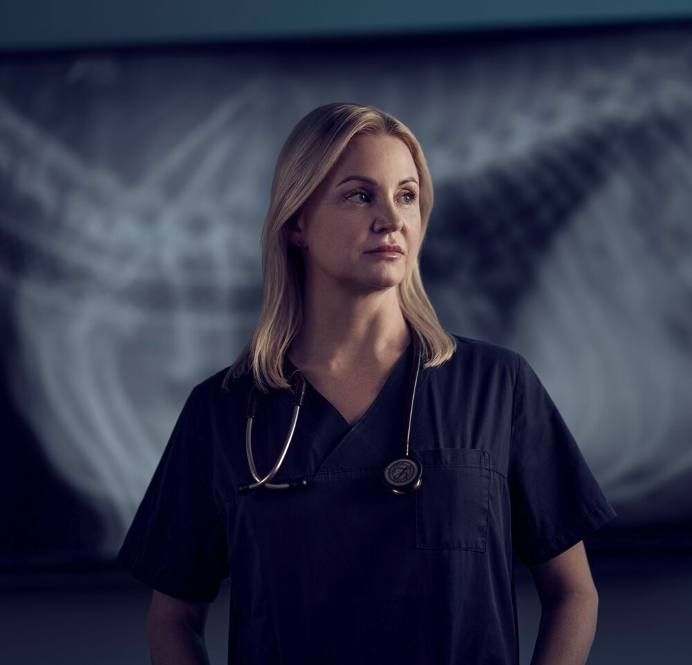 Eine Tier&auml;rztin steht vor einer R&ouml;ntgenaufnahme im Hintergrund.